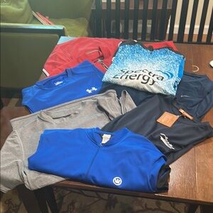 Assorted men’s bike riding and dry wick shirts